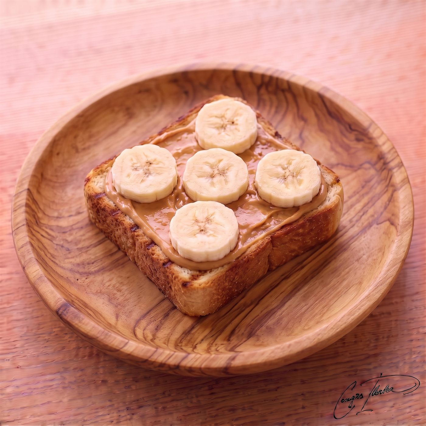 A thick, toasted square slice of bread resting on a carved wooden plate, generously spread with smooth peanut butter and topped with five perfectly arranged banana slices.