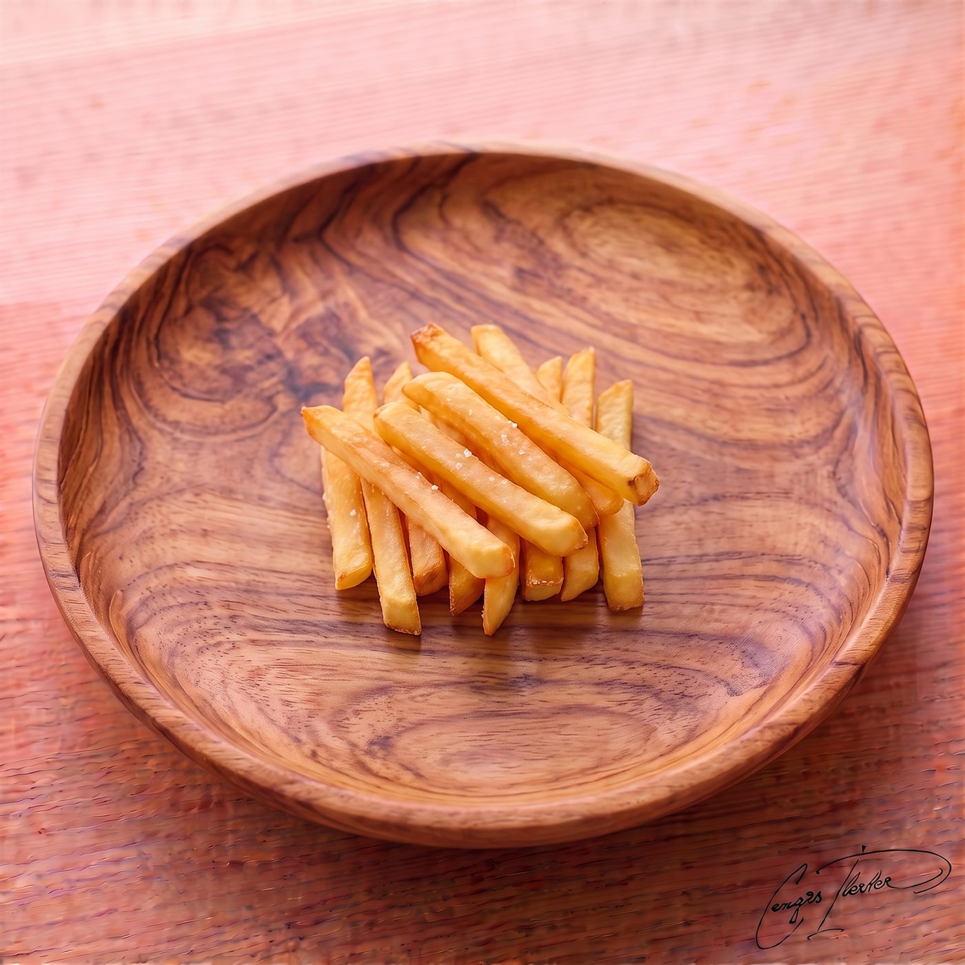 A neatly stacked pile of golden, perfectly fried patates kızartması (French fries) lightly dusted with coarse salt, served in a carved wooden bowl.