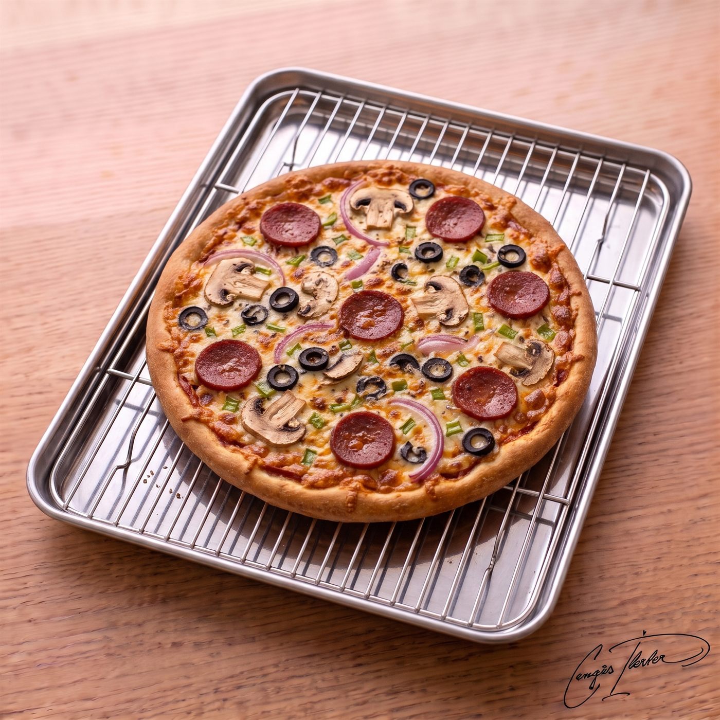 A whole Super Supreme Pizza baked to a golden brown, topped with pepperoni, sliced mushrooms, black olives, green peppers, and red onions, resting on a metal cooling rack over a baking sheet on a wooden table.